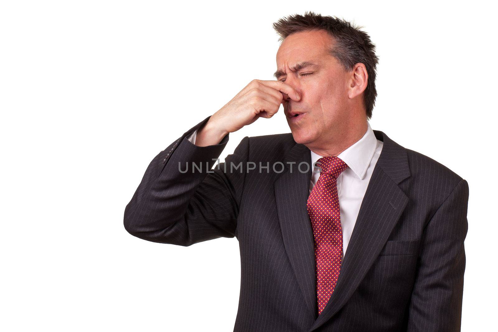 Middle Age Business Man in Suit Smelling Something Bad and Holding Nose Isolated