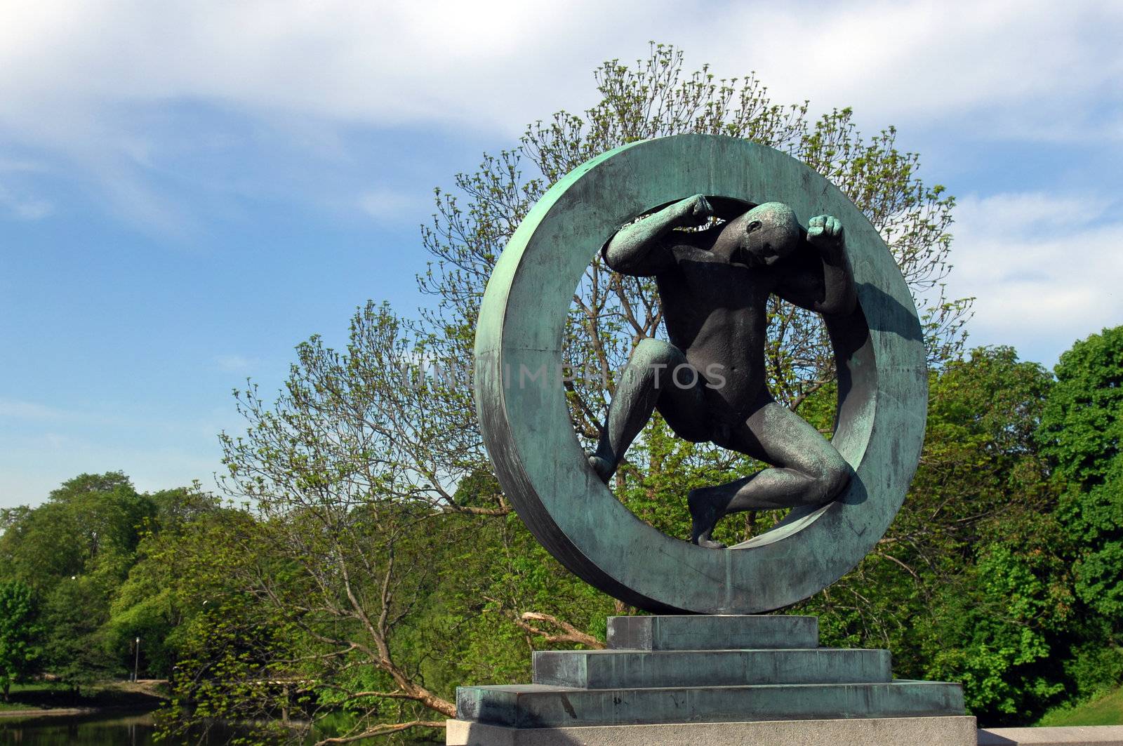 bronze sculpture of a man inside the wheel in Vigeland park, Oslo