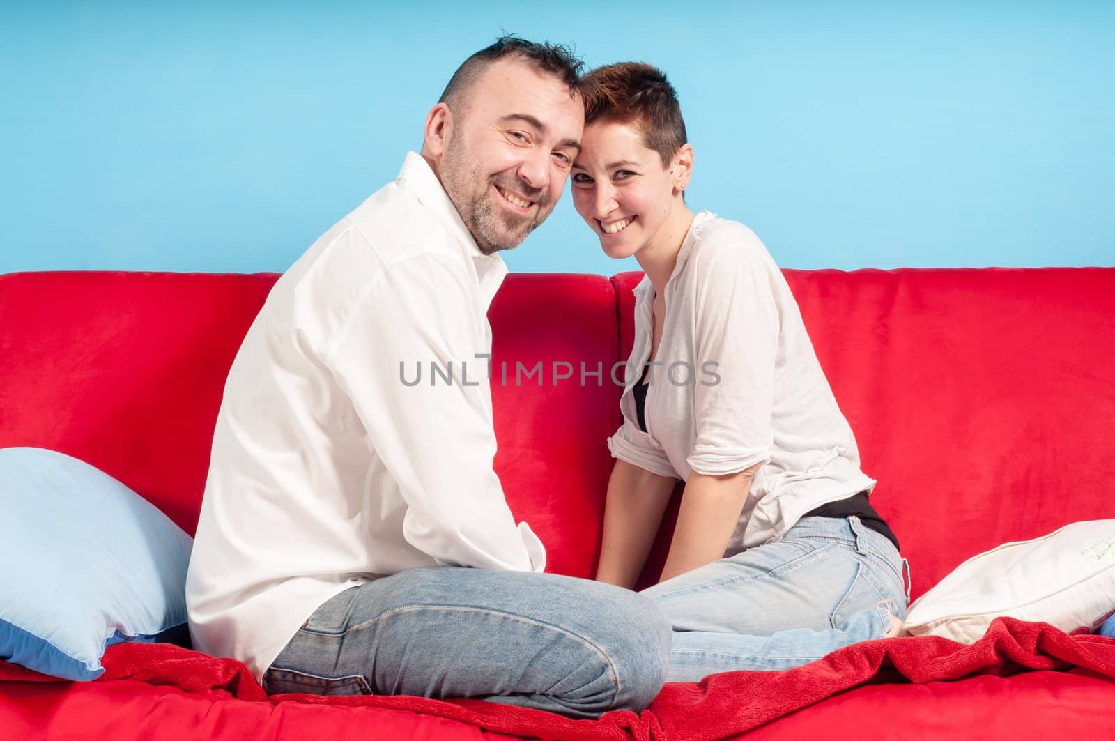 husband and wife hugging on the couch in the living room