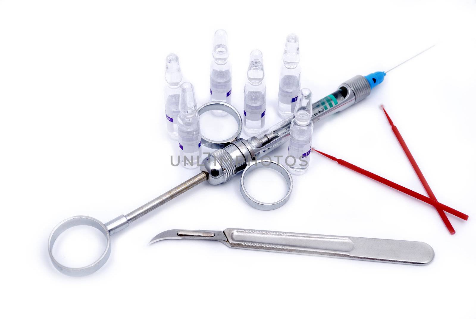 Medical instruments: a syringe, a scalpel and ampoules