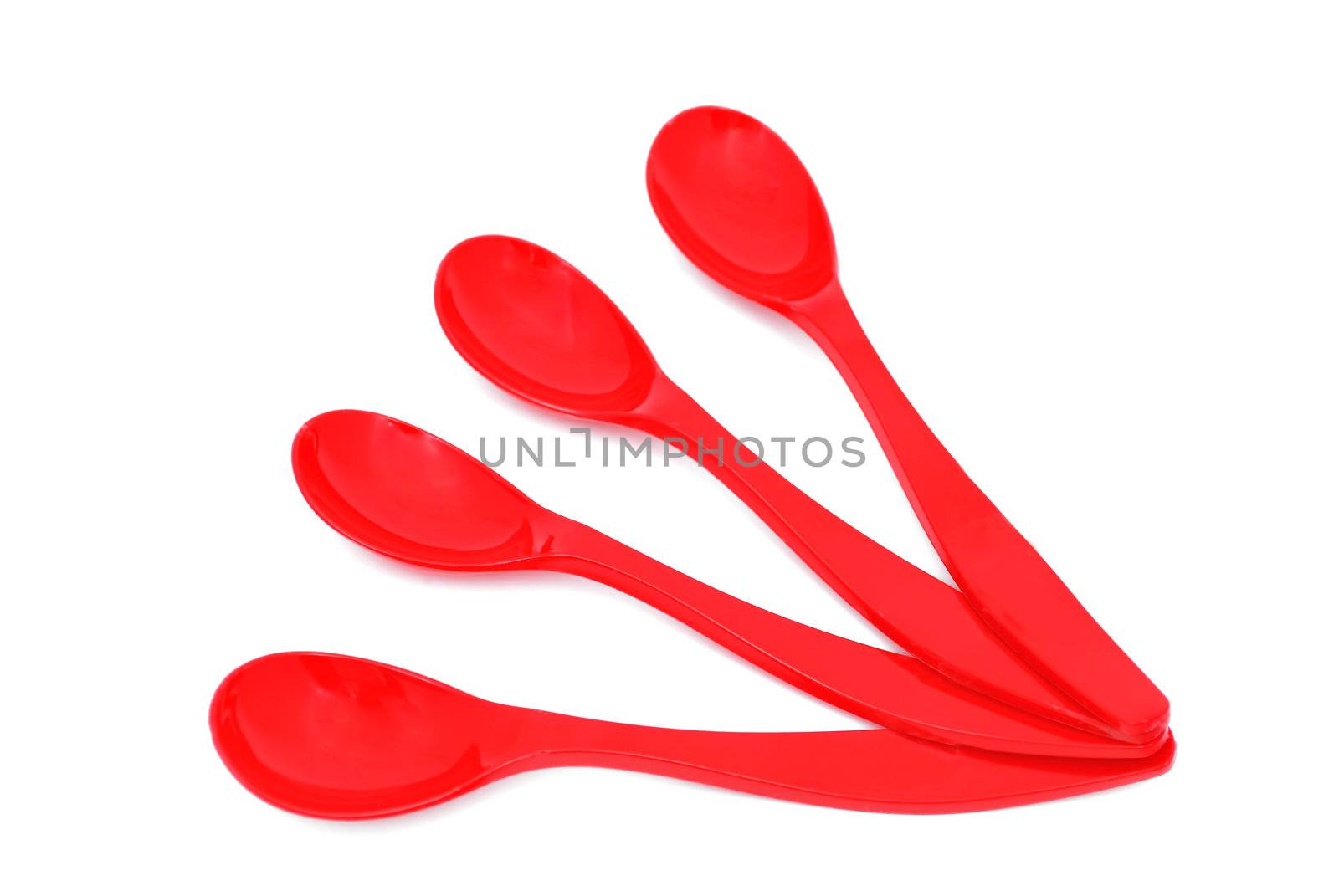 four children's spoons laid out like a fan on a white background