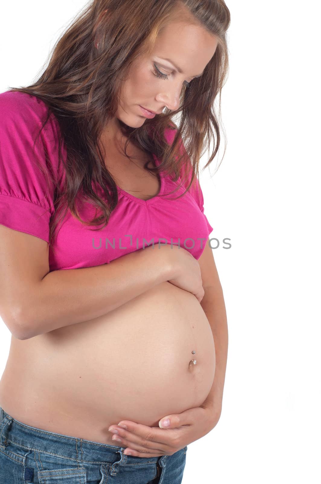 Beautiful pregnant woman in pink in studio isolated on white