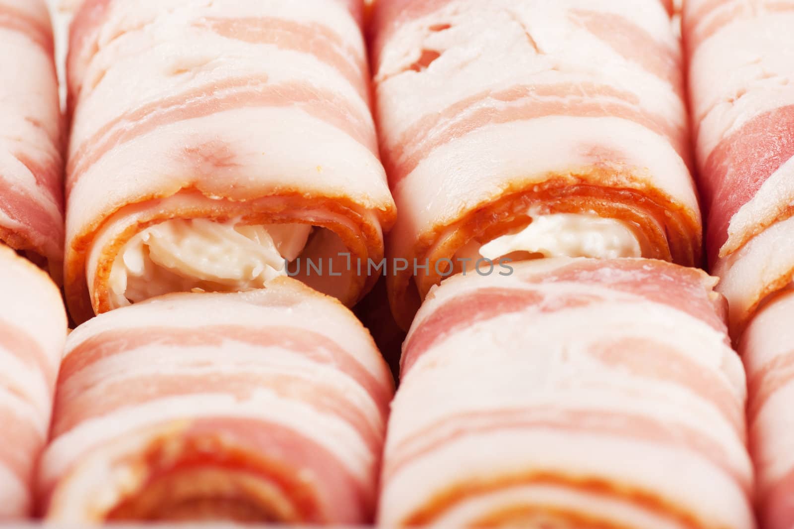 Closeup view of group of bacon rolls with filling