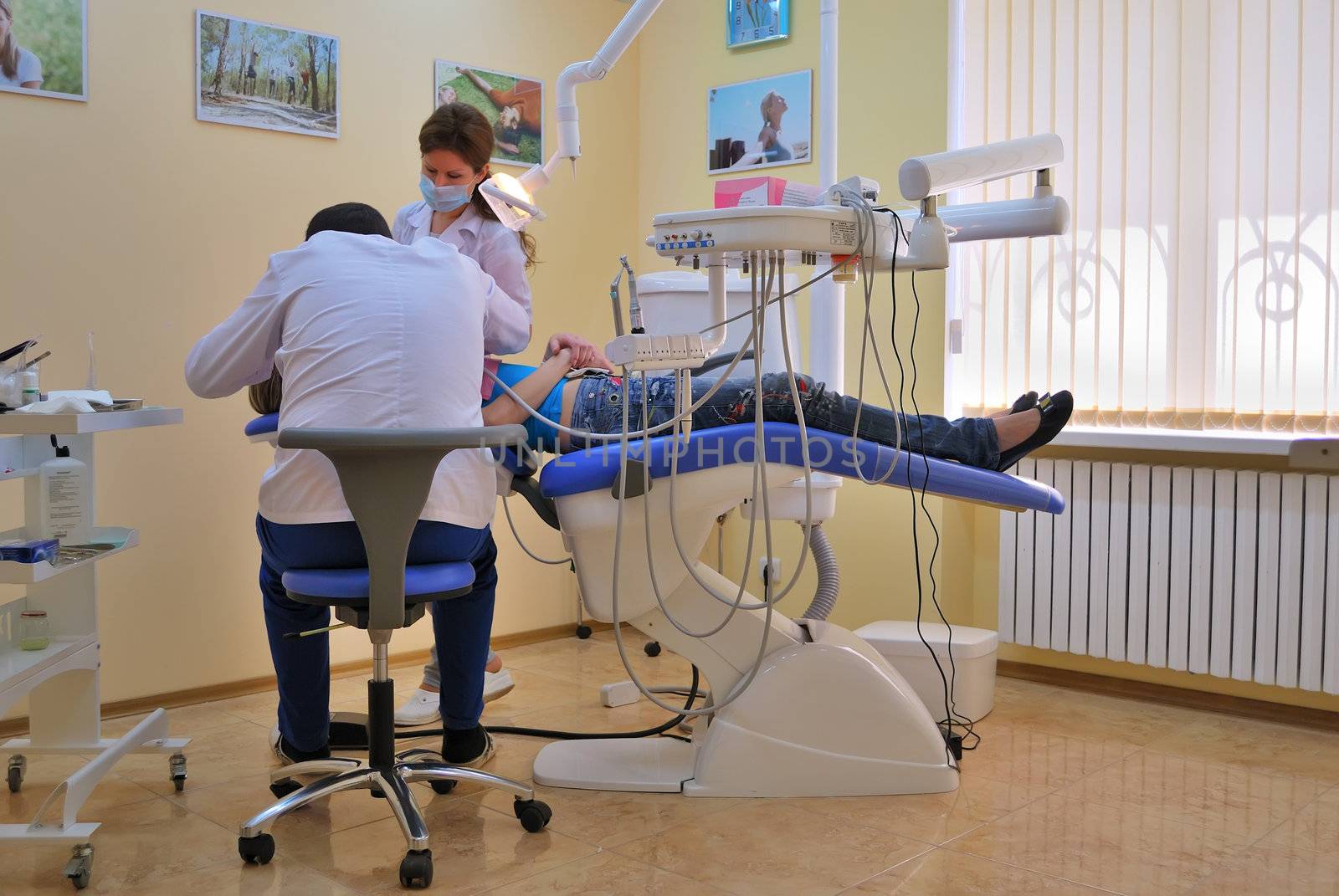 dentist and assistant operate on the patient