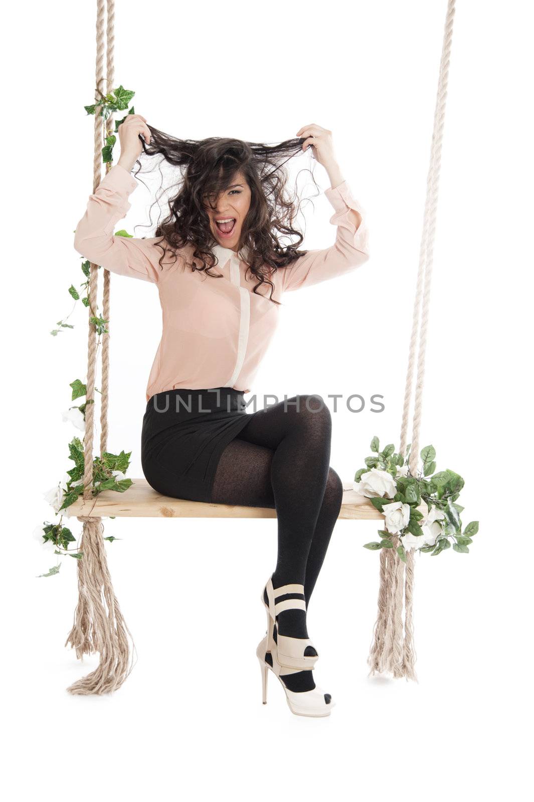 Woman joyfully shouts ruffled his hair, sitting on a swing.