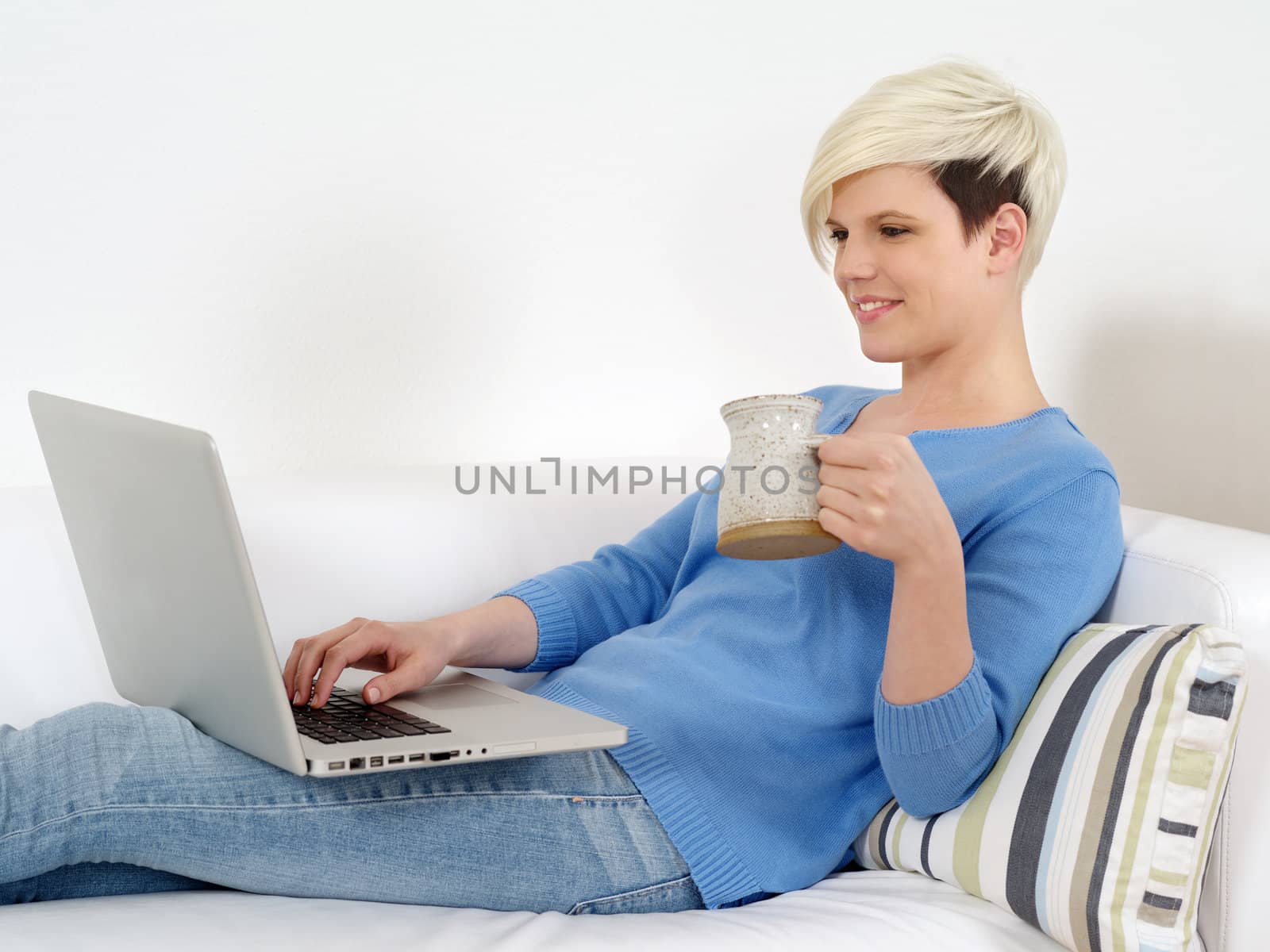 Pretty female sitting with laptop by sumners