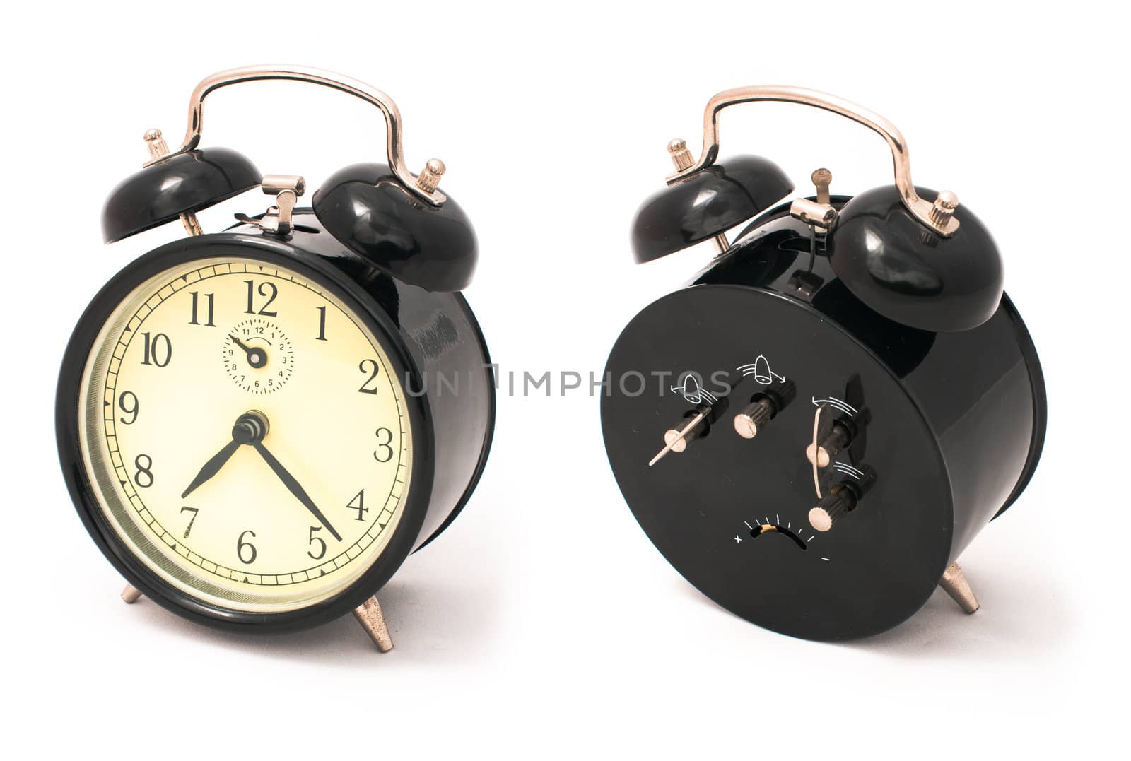 Old black alarm clock, front and back sides