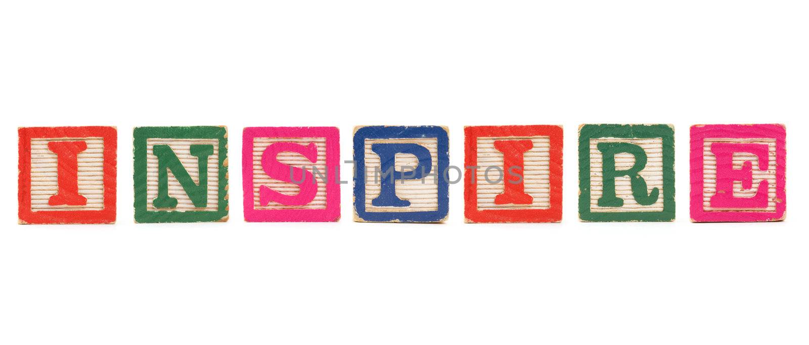 The word "INSPIRE" created with children's blocks