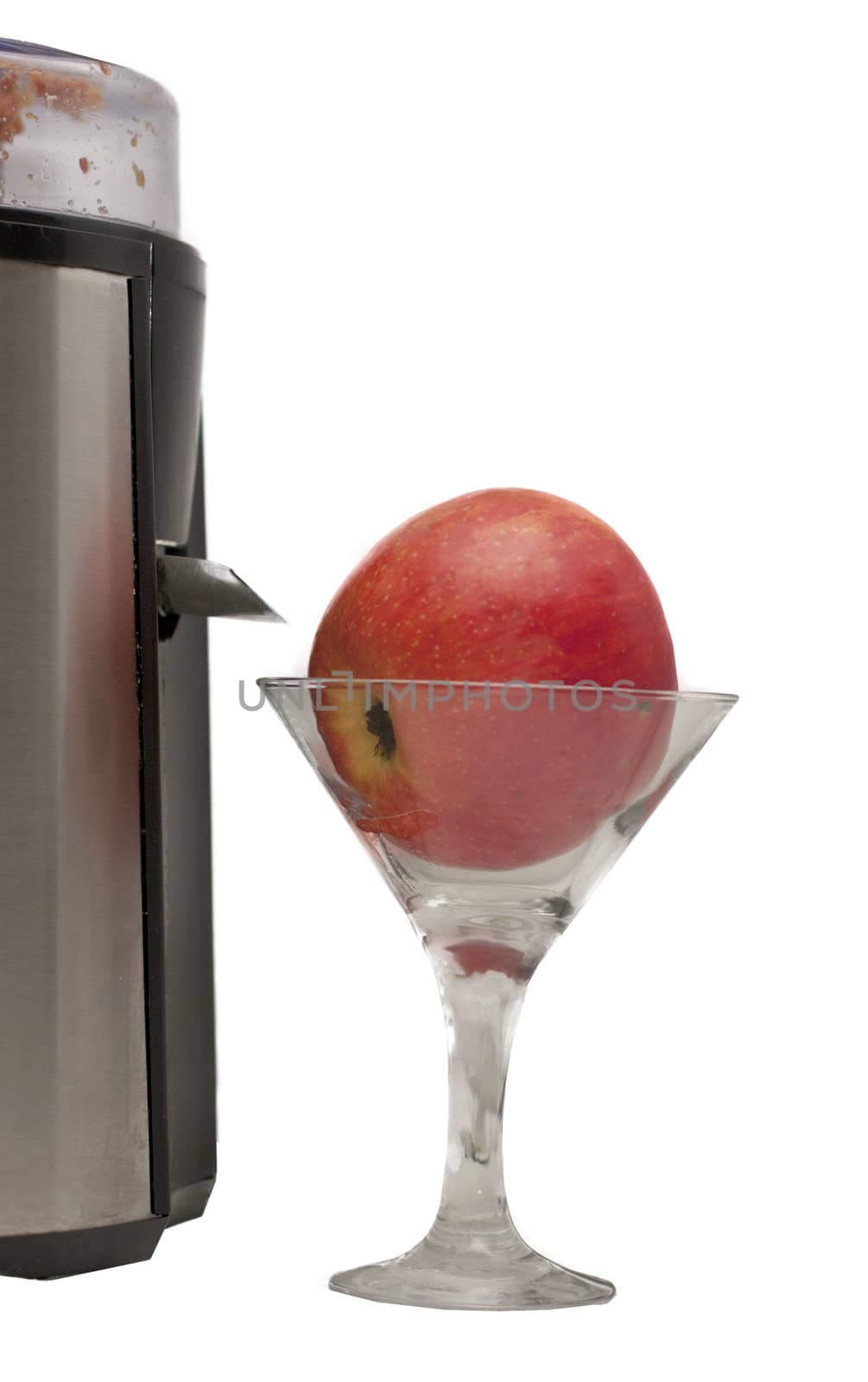 apple in a glass and a juicer on a white background