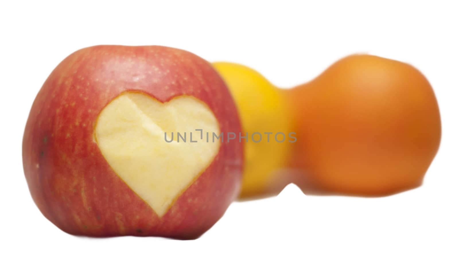 apple with a heart carved on a white