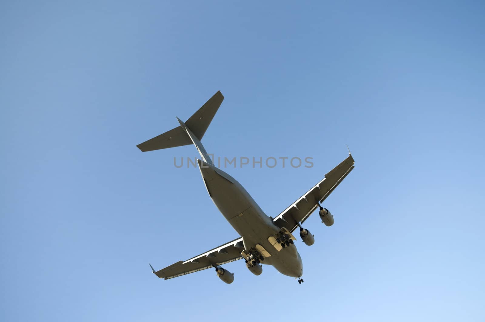 Transport plane landing with blue sky in the background