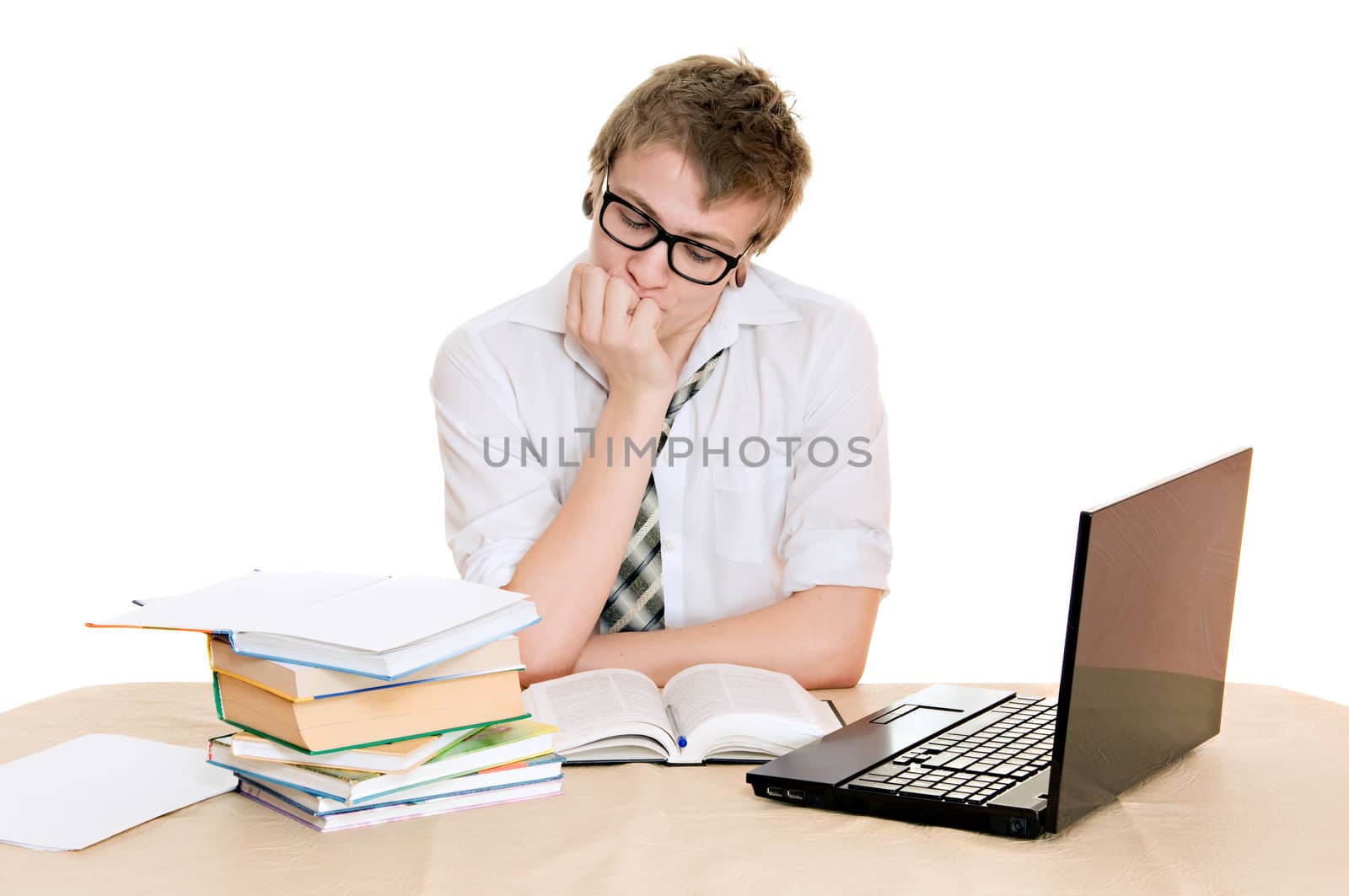 teenager student sits behind a desk isolated on white background