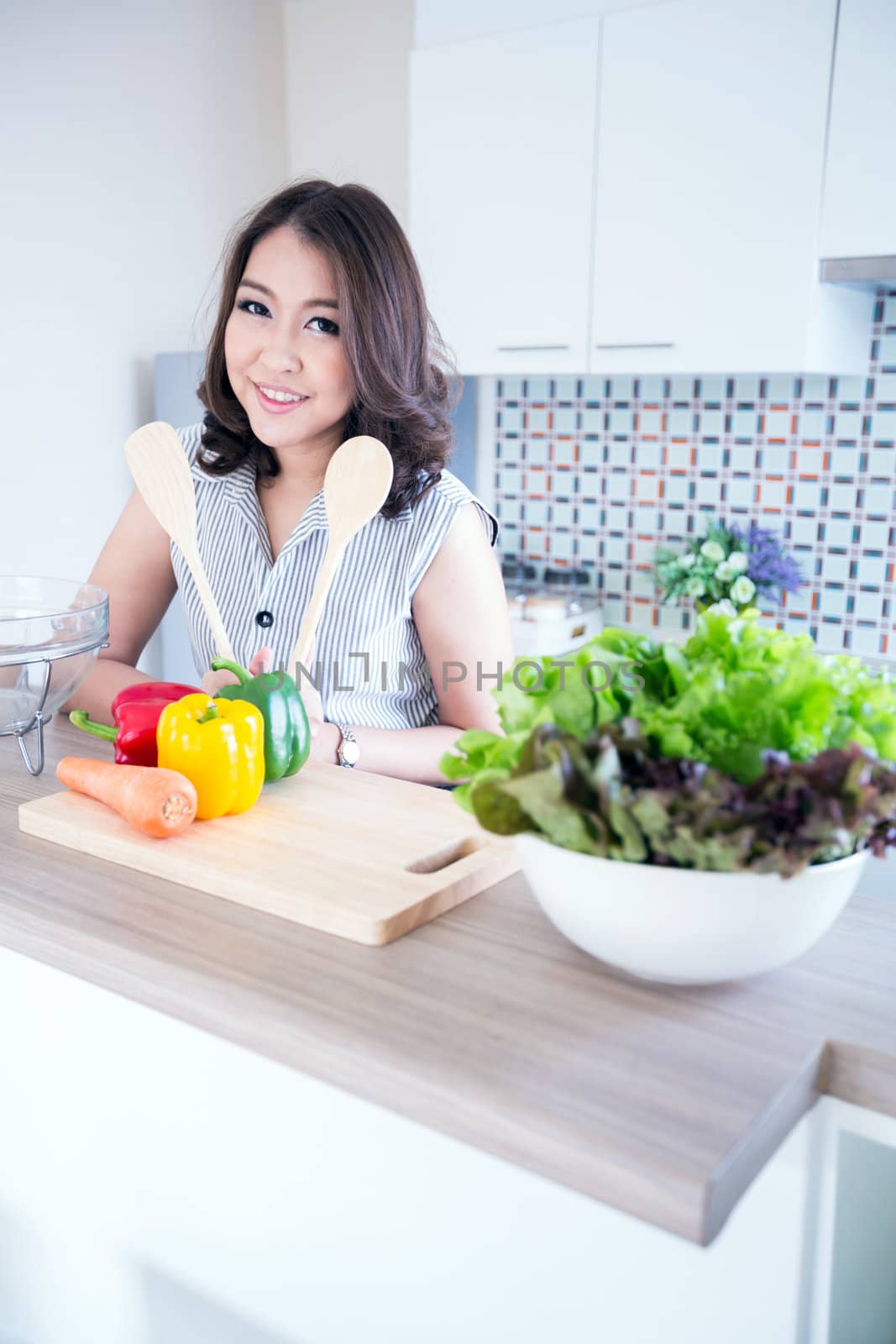 Portrait of beautiful relaxed young woman standing at the kitchen counter