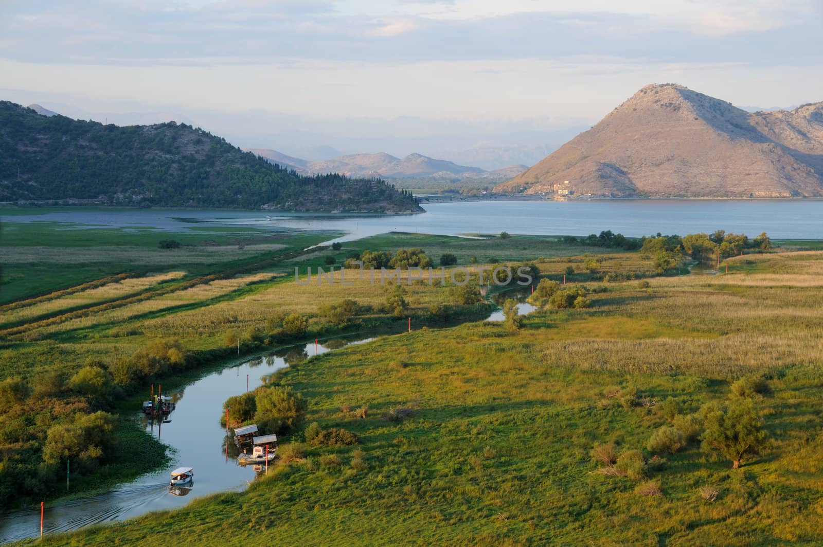 Skadar lake landscape with river and meadow in the foreground