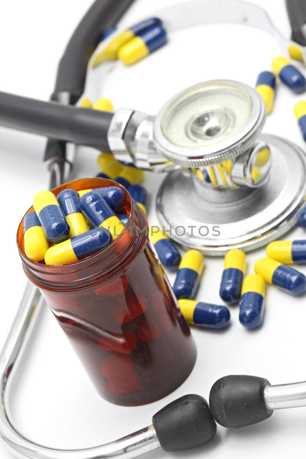 Perspective of Medical Stethoscope and Capsule on white background for Healthy Concept (selective focus at Pillbox)