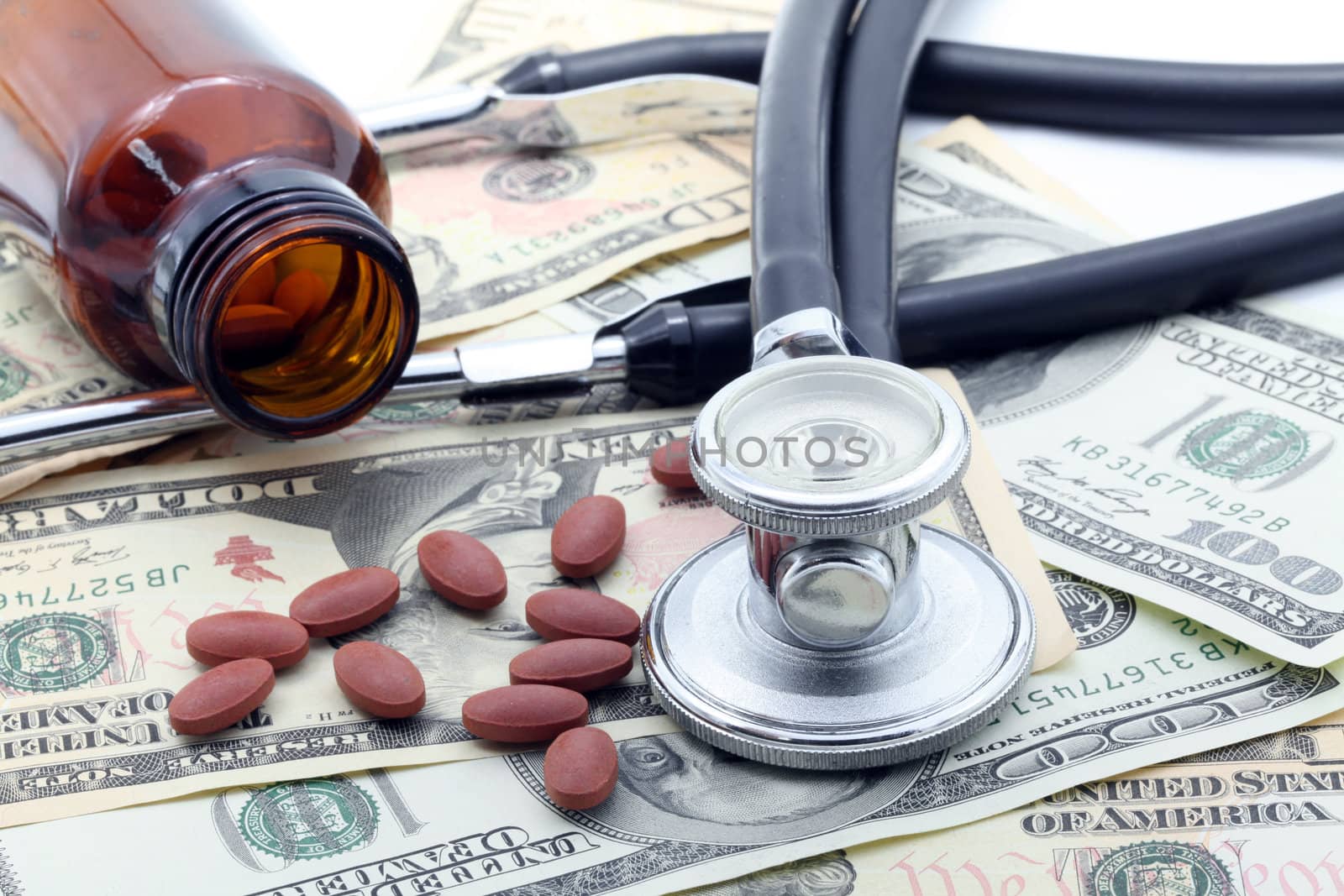 Medical Stethoscope and Pills on Dollars