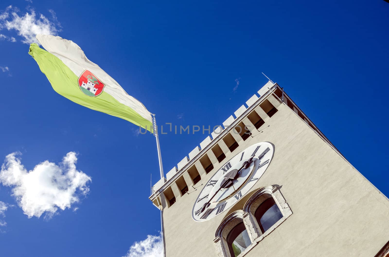 Clock tower of Ljubljana castle with town flag.