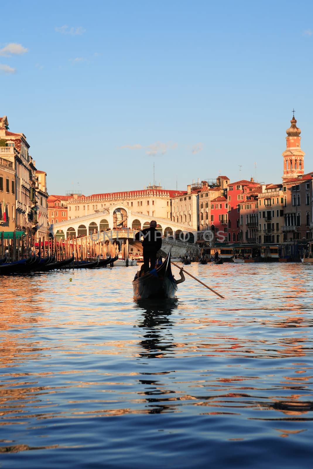 Venice,Italy. January 6, 2012. Black gondola at Grand Canal against Rialto Bridge