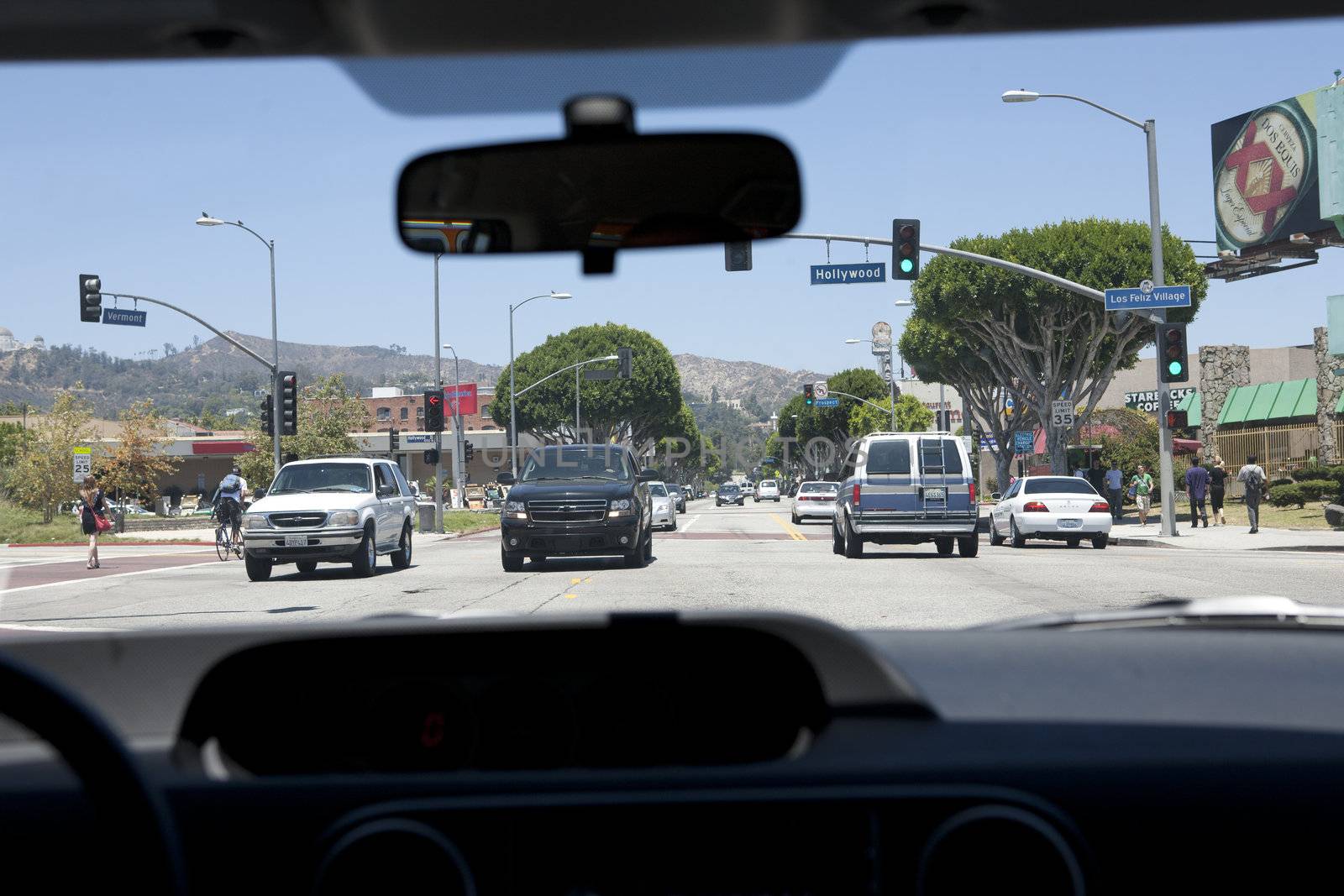 View of Hollywood Boulvard in Los Angeles, CA from a front seat inside a car.