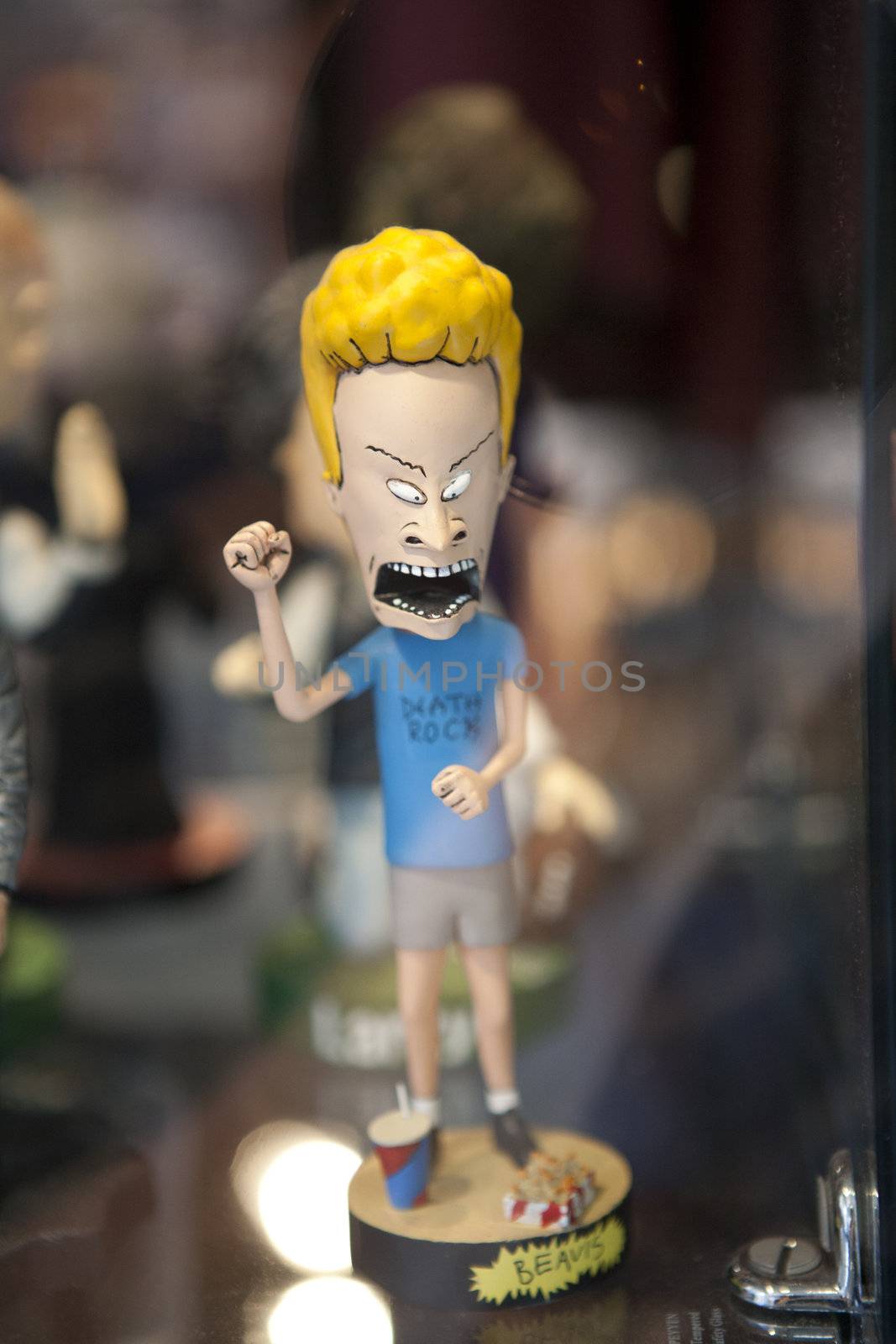 Beavis from "Beavis and Butthead" bobblehead character, behind glass.