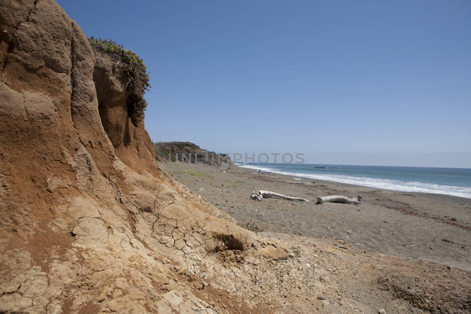 Dry mud and sandy beach off Highway 1 in California.