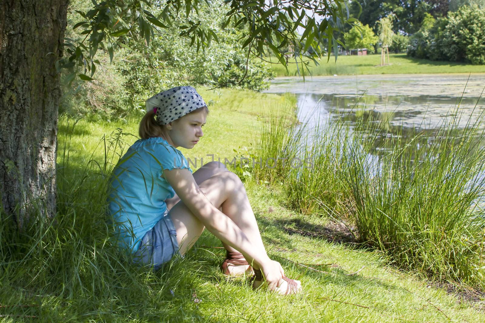  little girl sitting by the water  by miradrozdowski