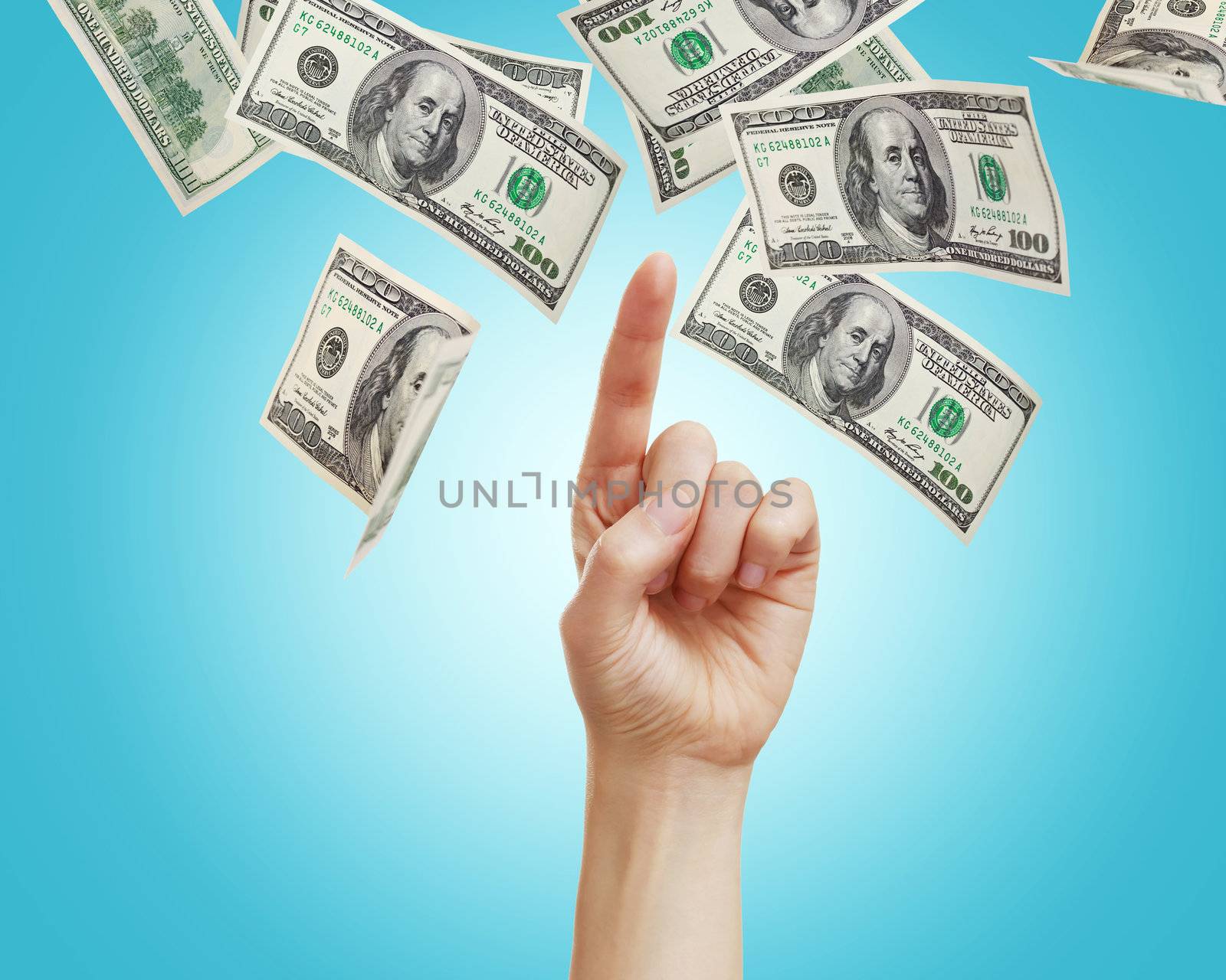 Hand pointing to hundred dollar bills 