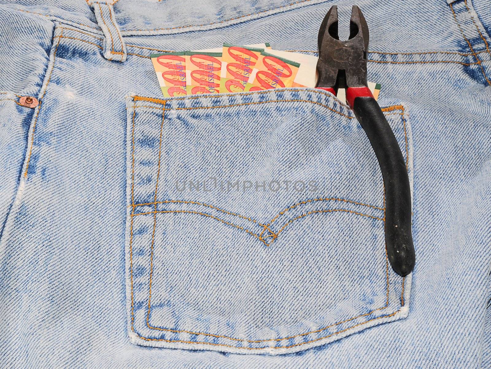 Israel Shekel Bills And Pliers In Hip Pocket Of Jeans.