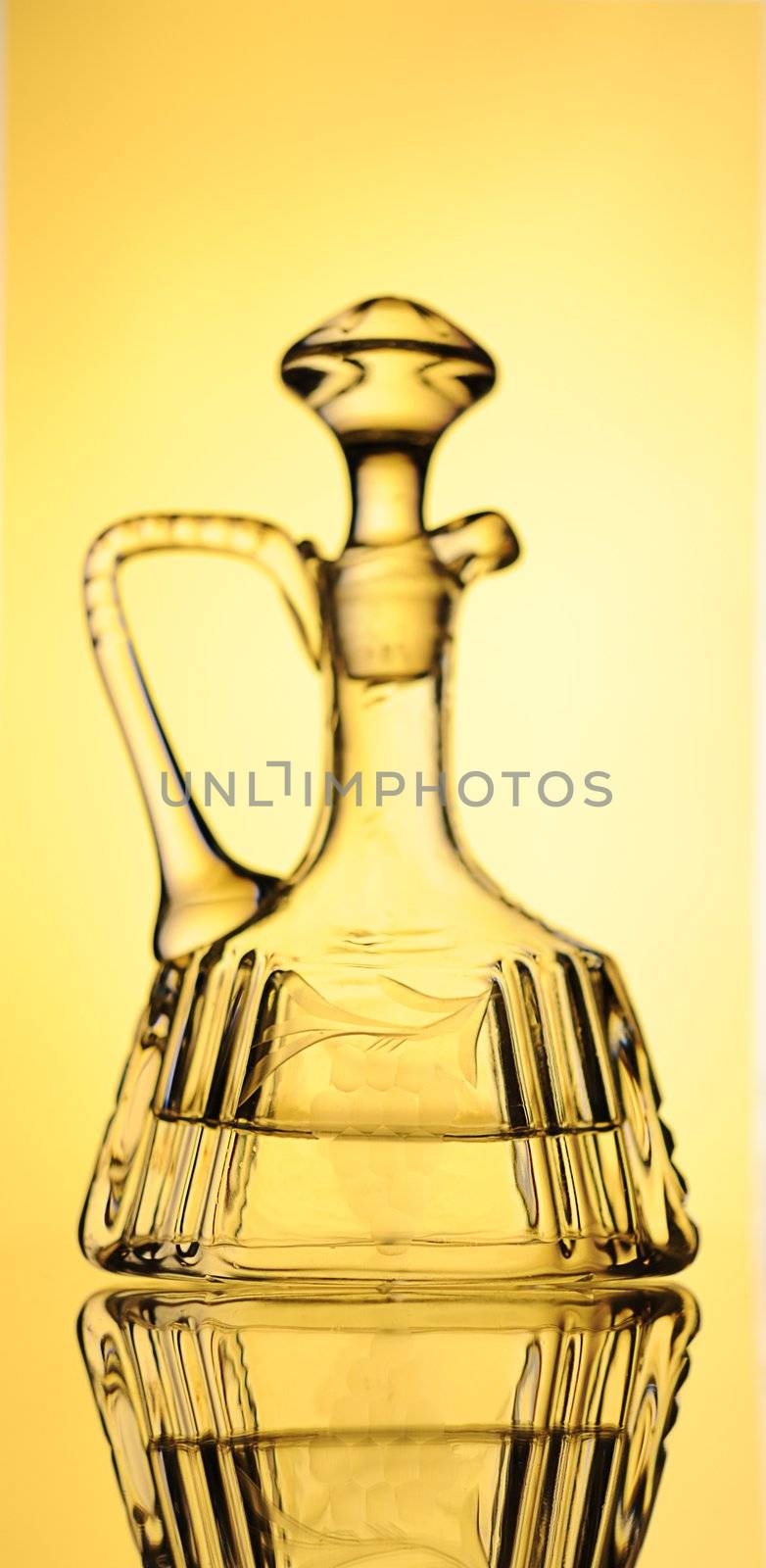 Elegant Crystal Decanter With Vodka Over Yellow  Background.