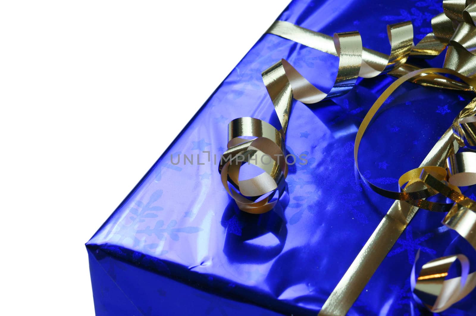Shiny blue gift with gold ribbons, shallow depth of field, focus on ribbons