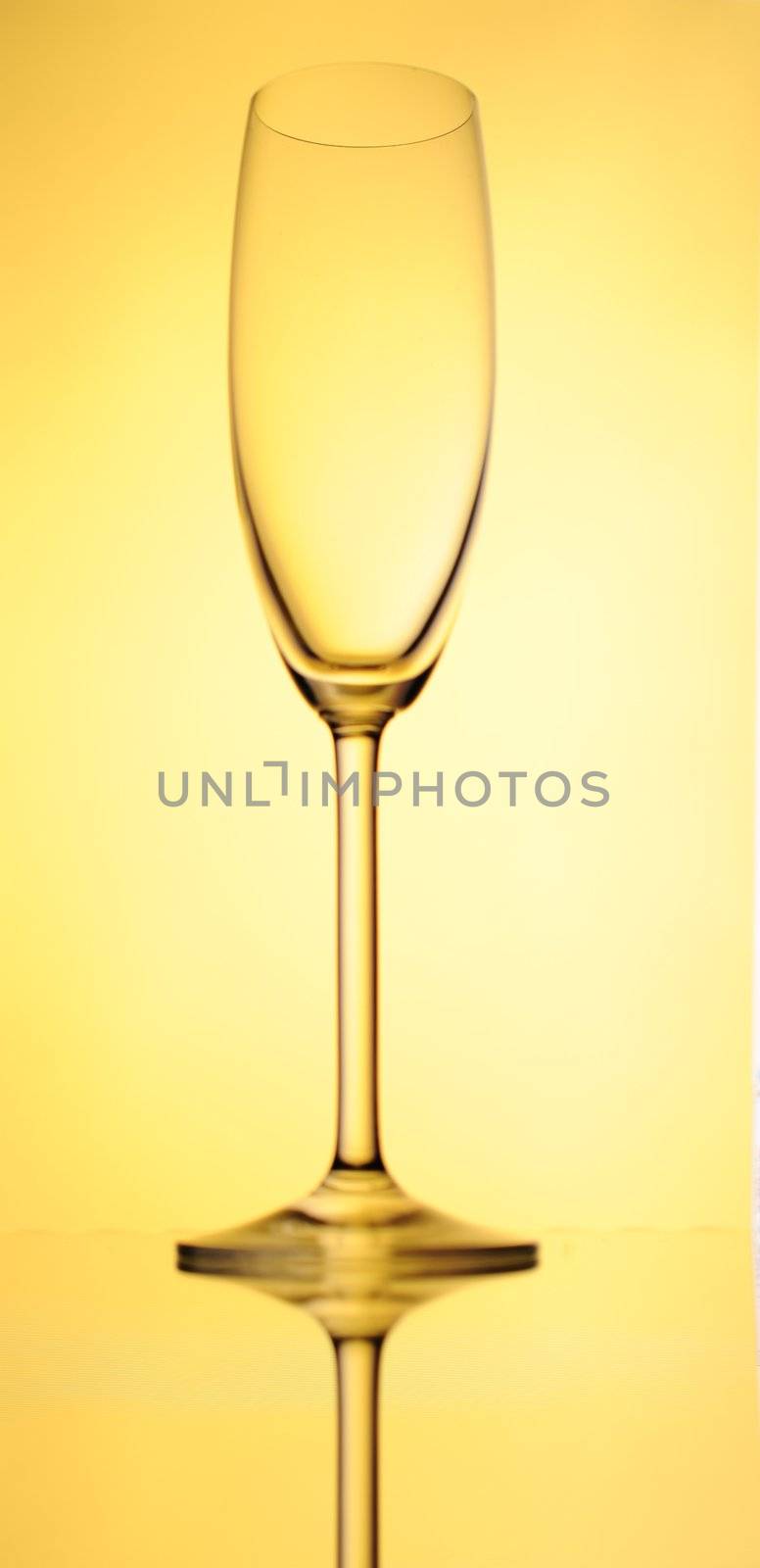 Elegant Crystal Wine Glass Over Yellow  Background.