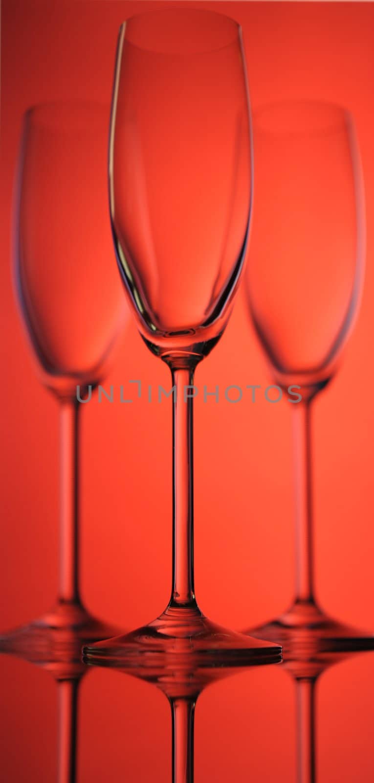 Tree Elegant Tall Wineglass For Champagne  Over Red  Background.