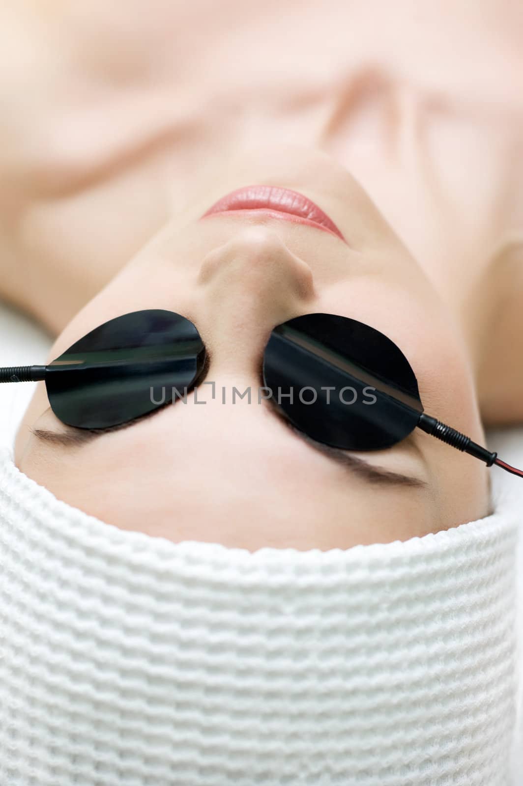 beauty salon, body care series. zone electrophoresis procedure applying on eyelids. selective focus.