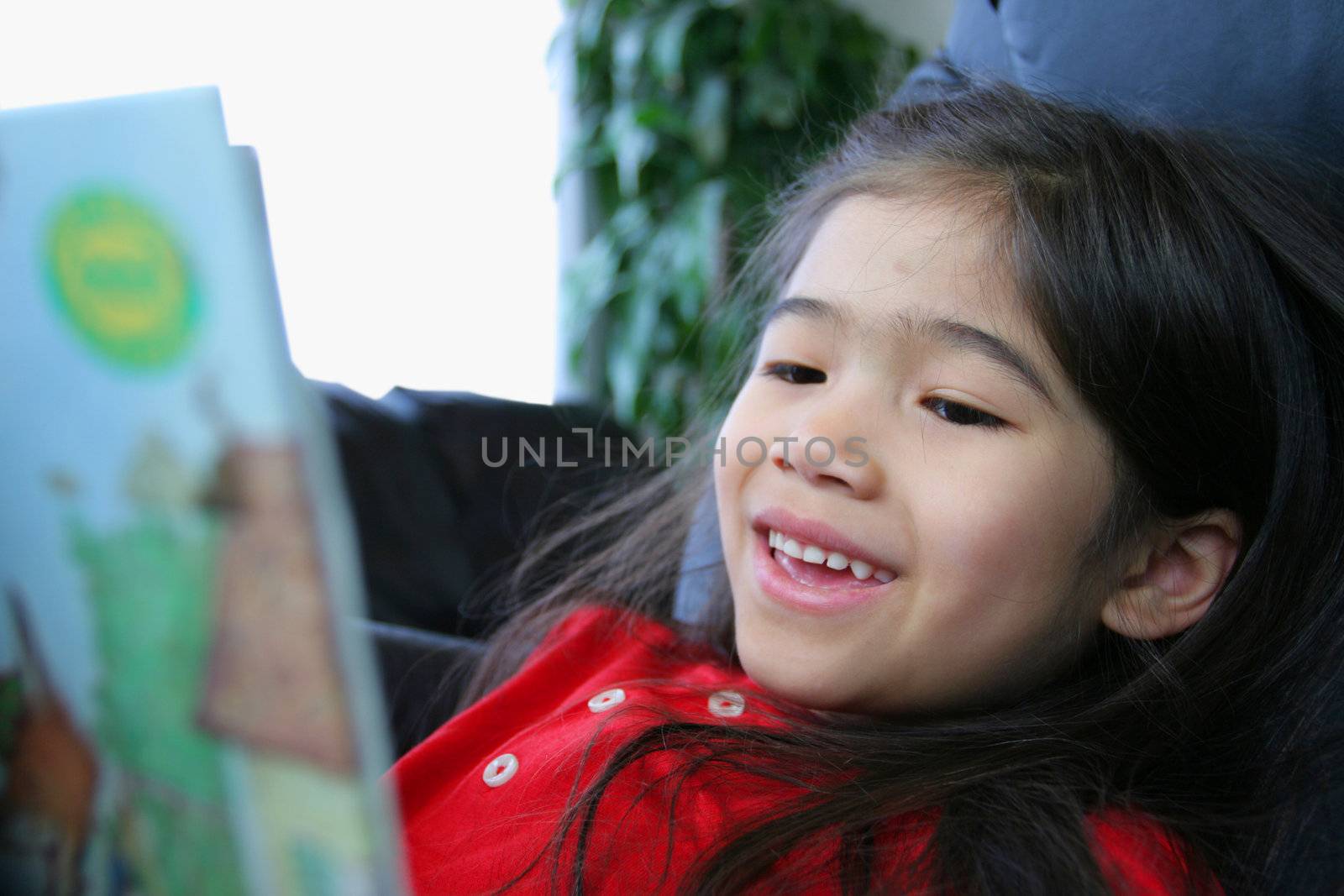 Child happily reading a book