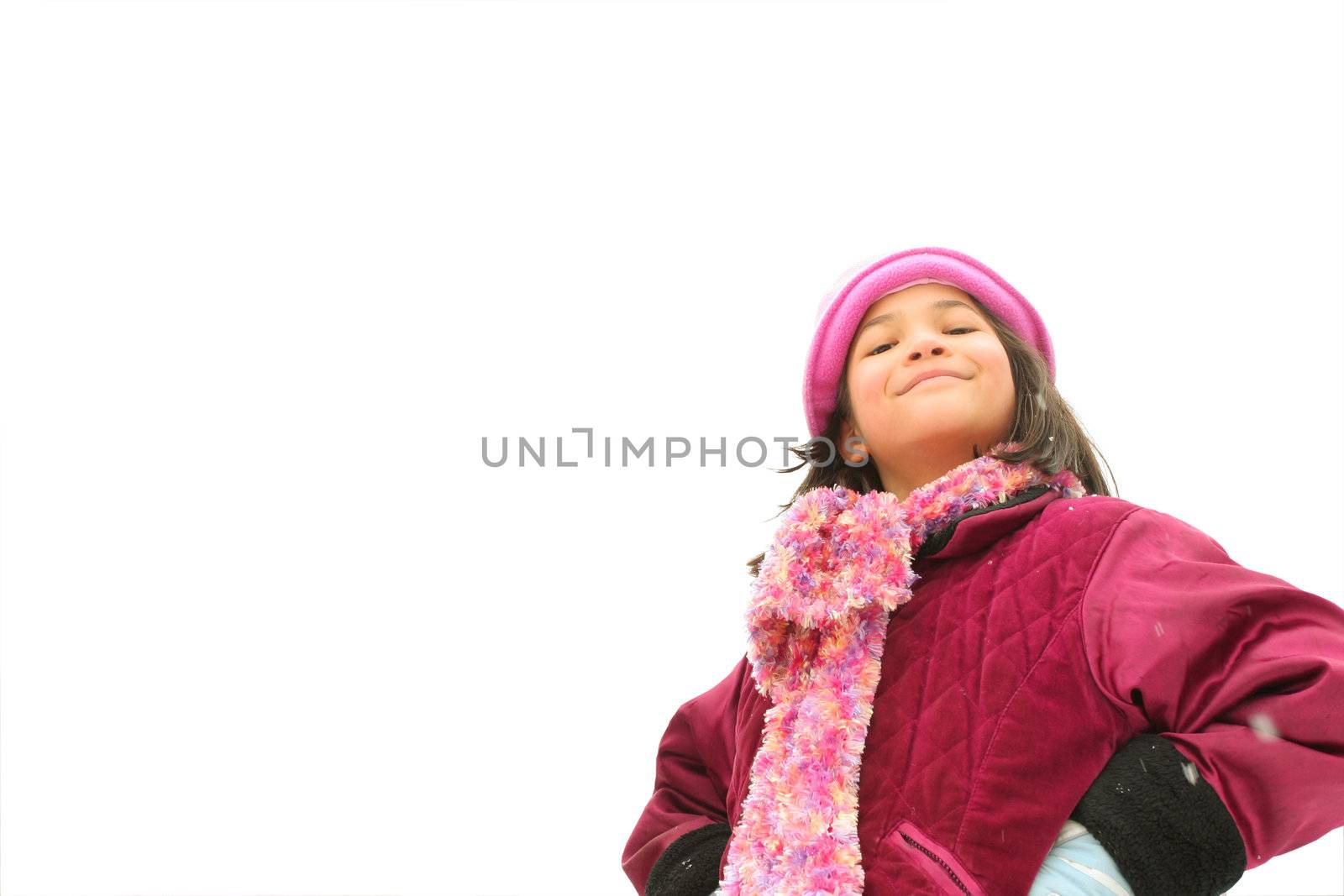 Child with challenging expression standing outdoors in winter