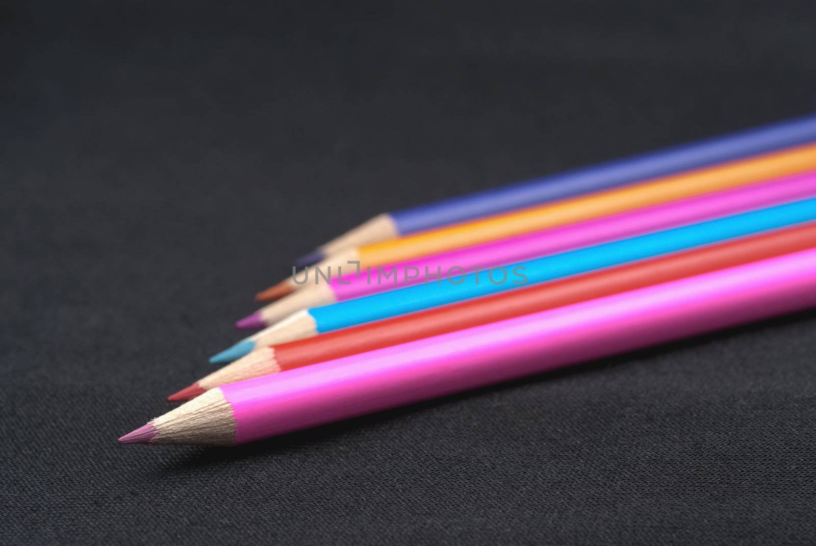 colored pencils close-up on a dark background