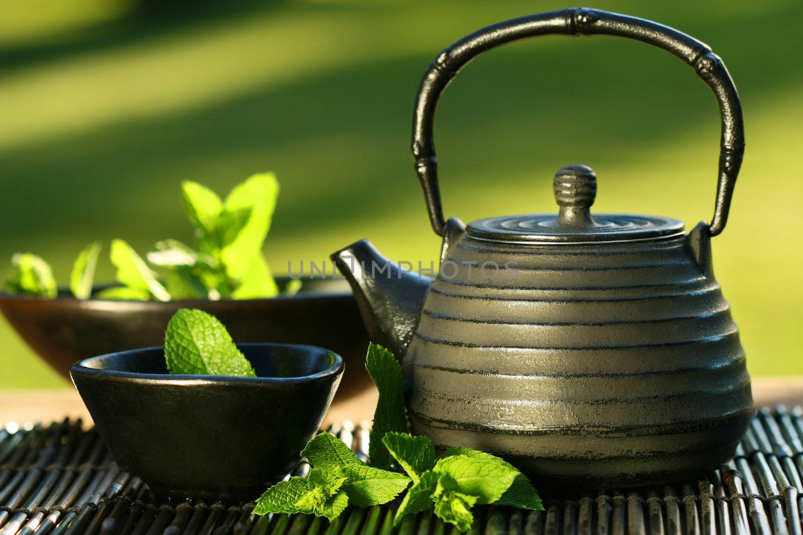 Black asian teapot with mint tea by Sandralise