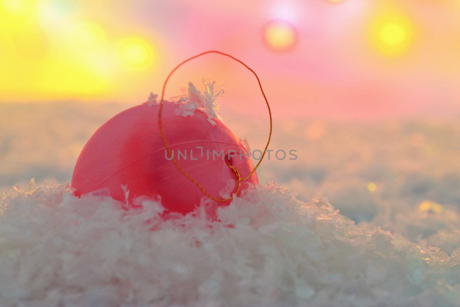 Christmas trinkets in the snow covered the setting sun