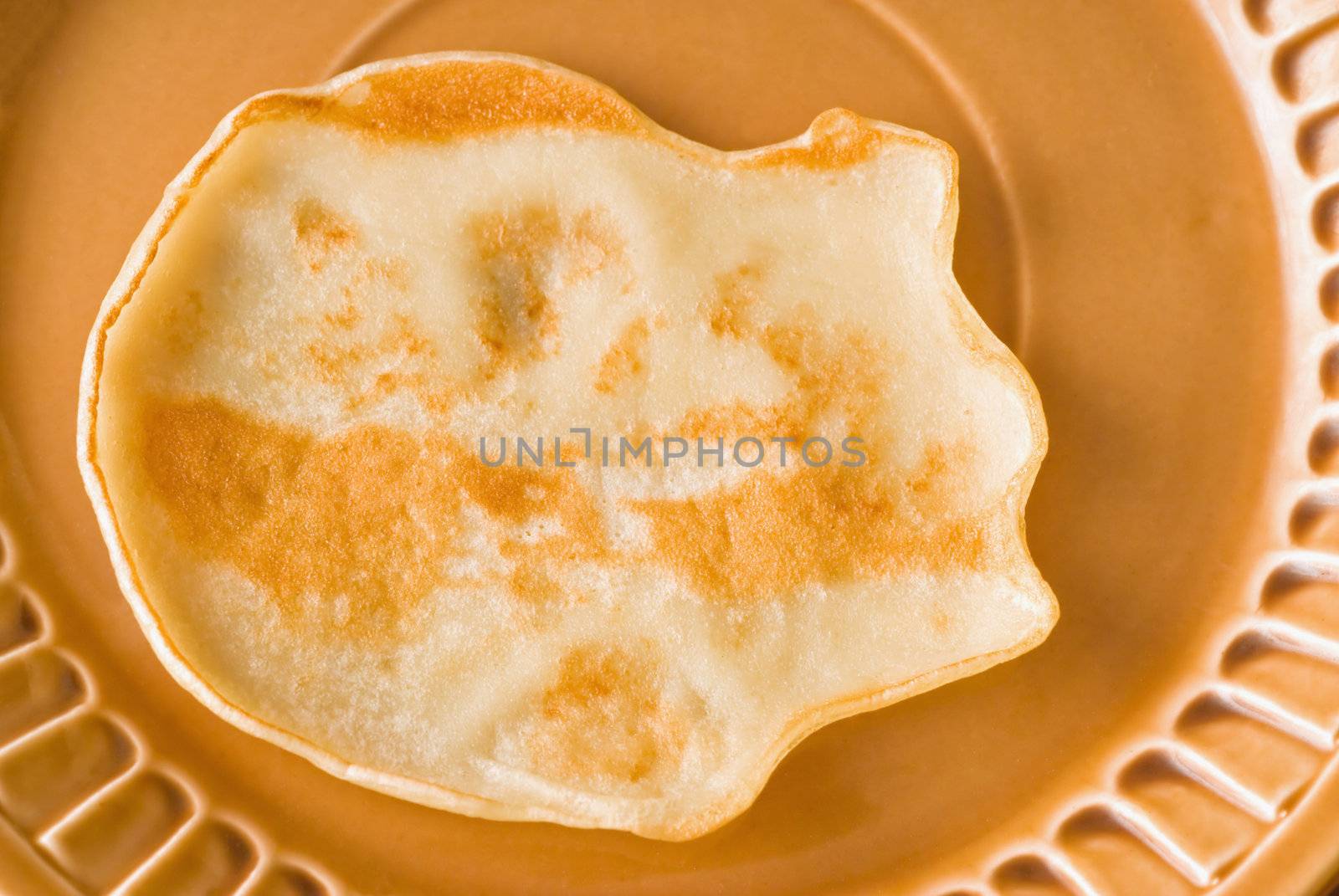 pancake rests on a plate ready for breakfast