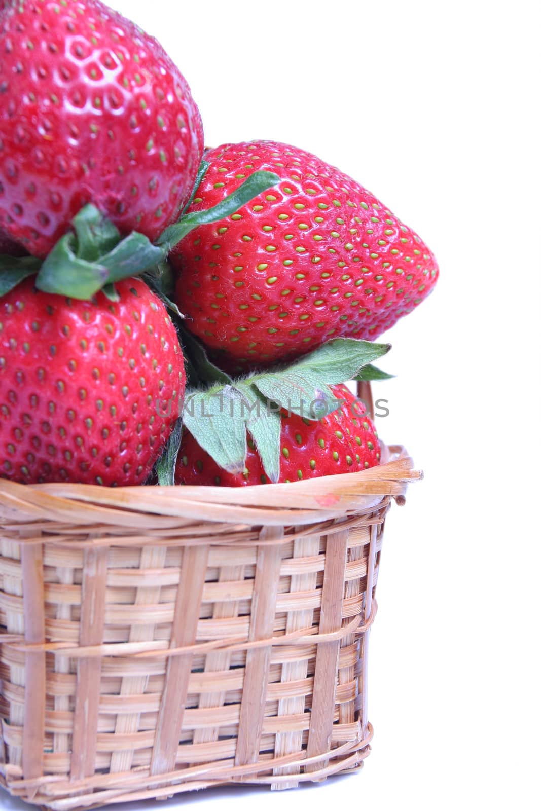 Small basket of strawberries on white