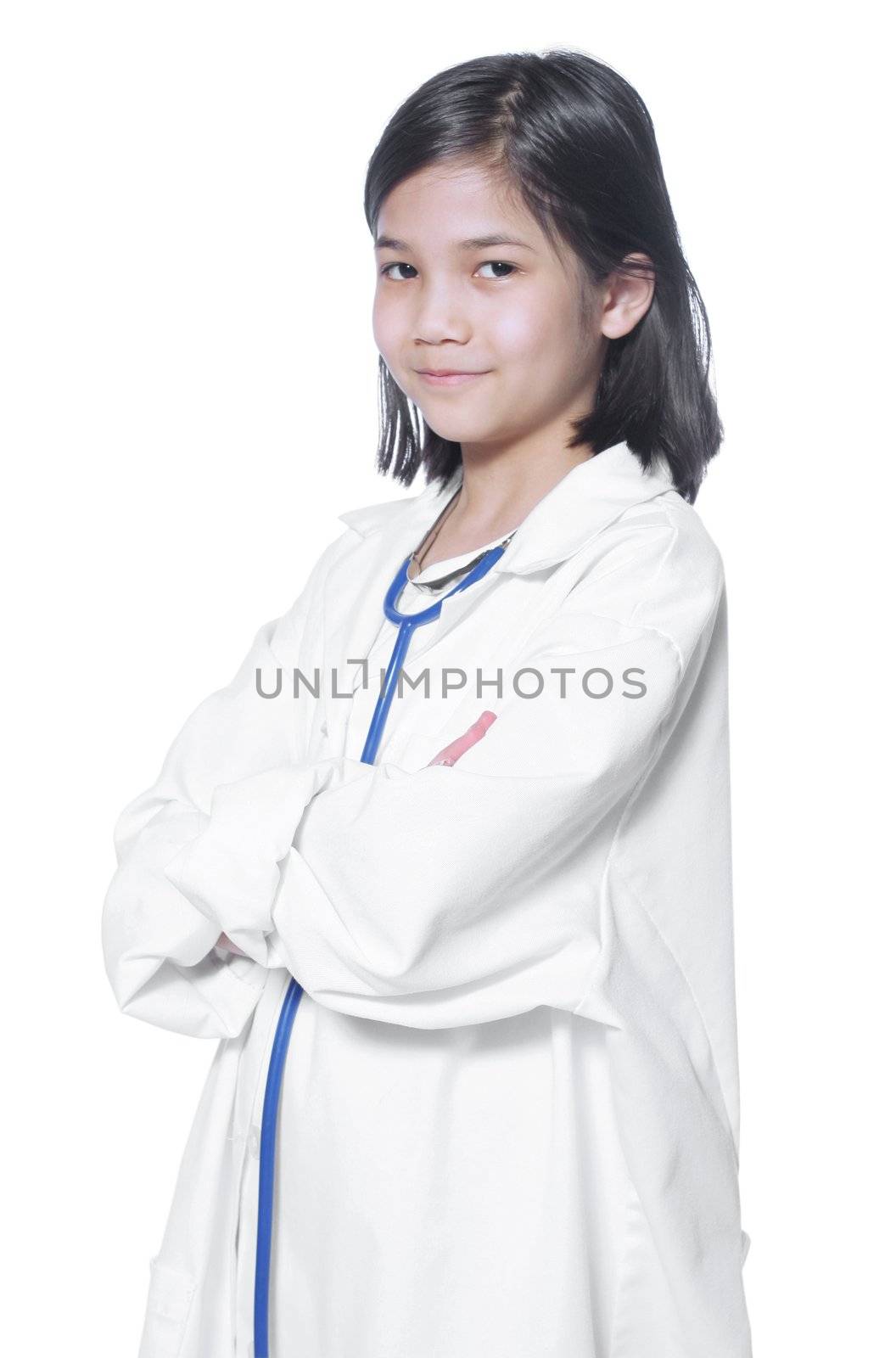 Nine year old girl playing doctor with white lab coat and stethoscope