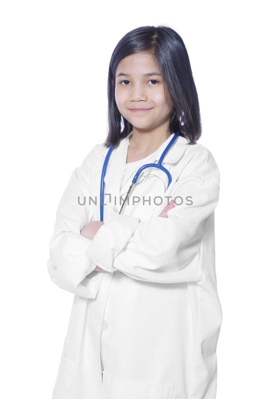 Nine year old girl playing doctor with white lab coat and stethoscope