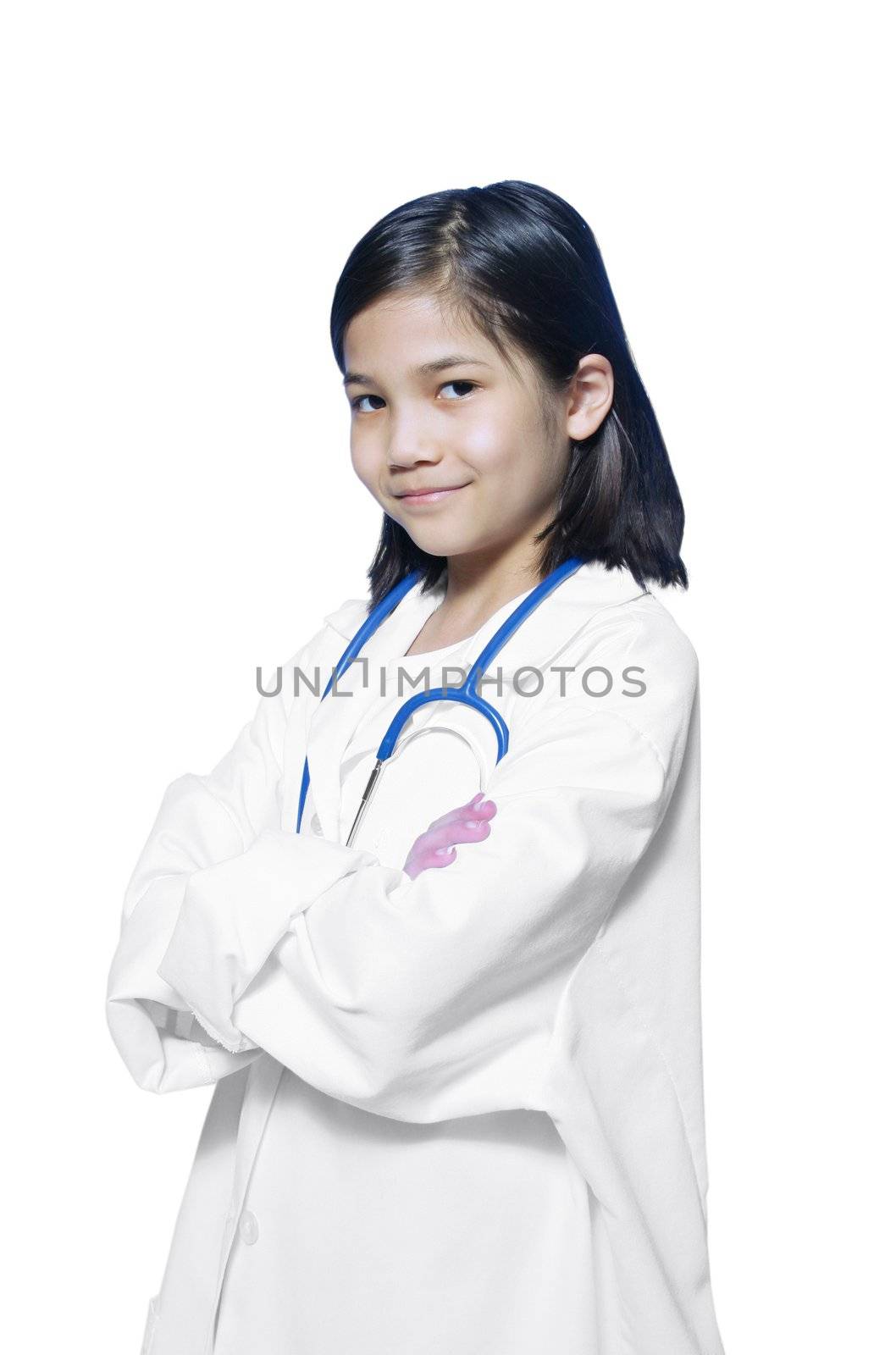 Nine year old girl playing doctor with white lab coat and stethoscope
