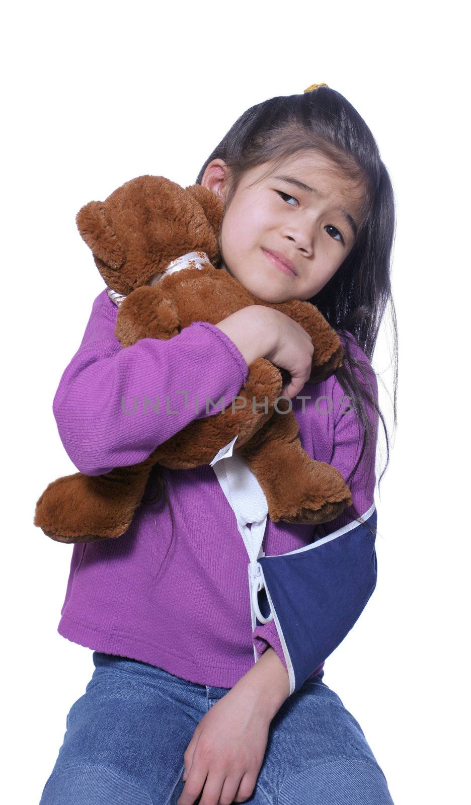 Little girl with broken arm holding doll