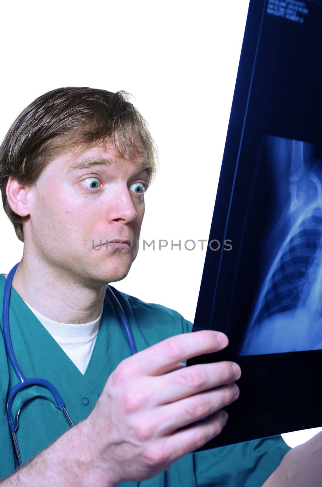 Male doctor looking with humorous shock at x ray