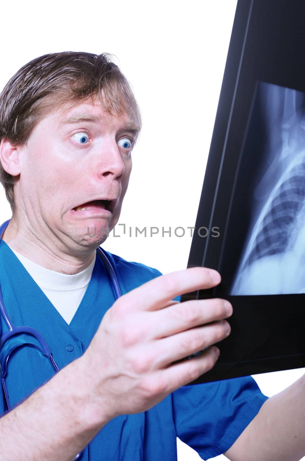 Male doctor looking with humorous shock at x ray