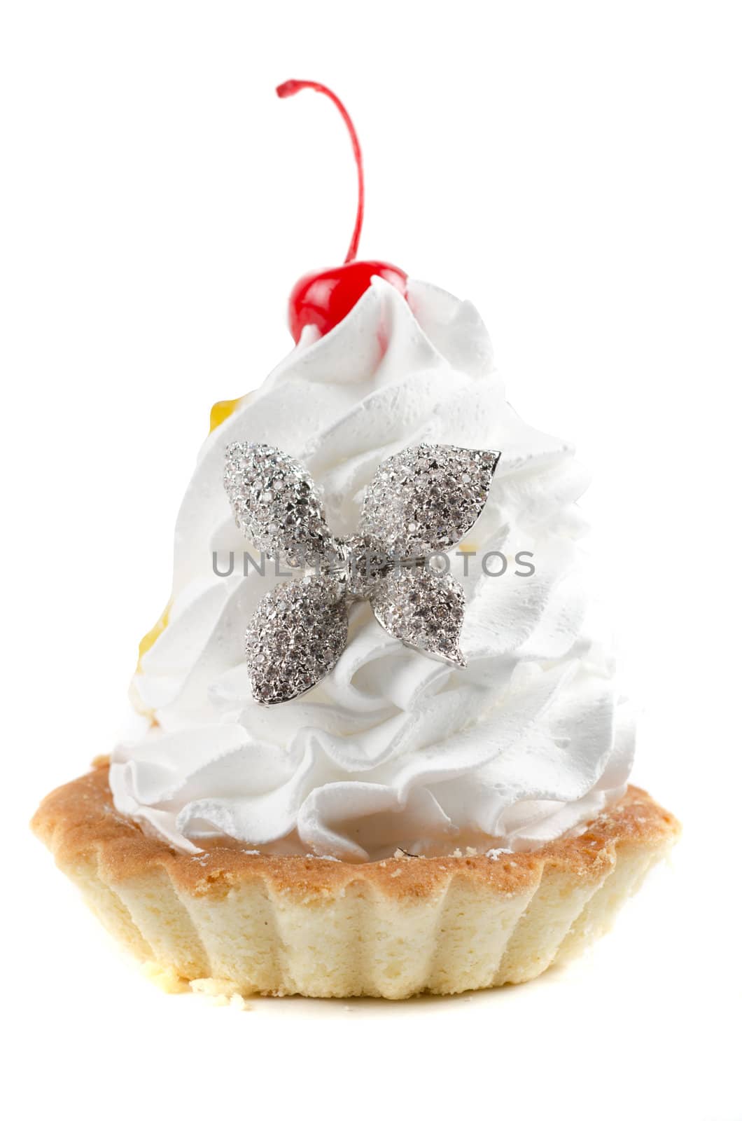 cupcake and bijouterie flower on a white background