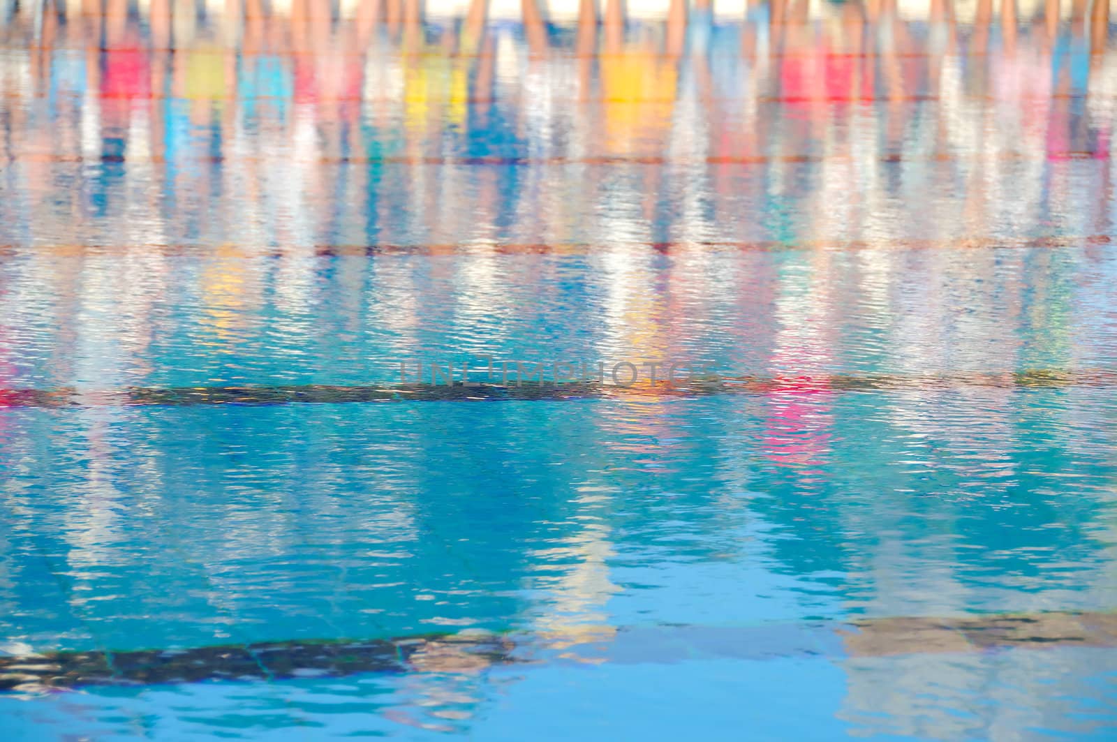 Reflection of people in a swimming pool