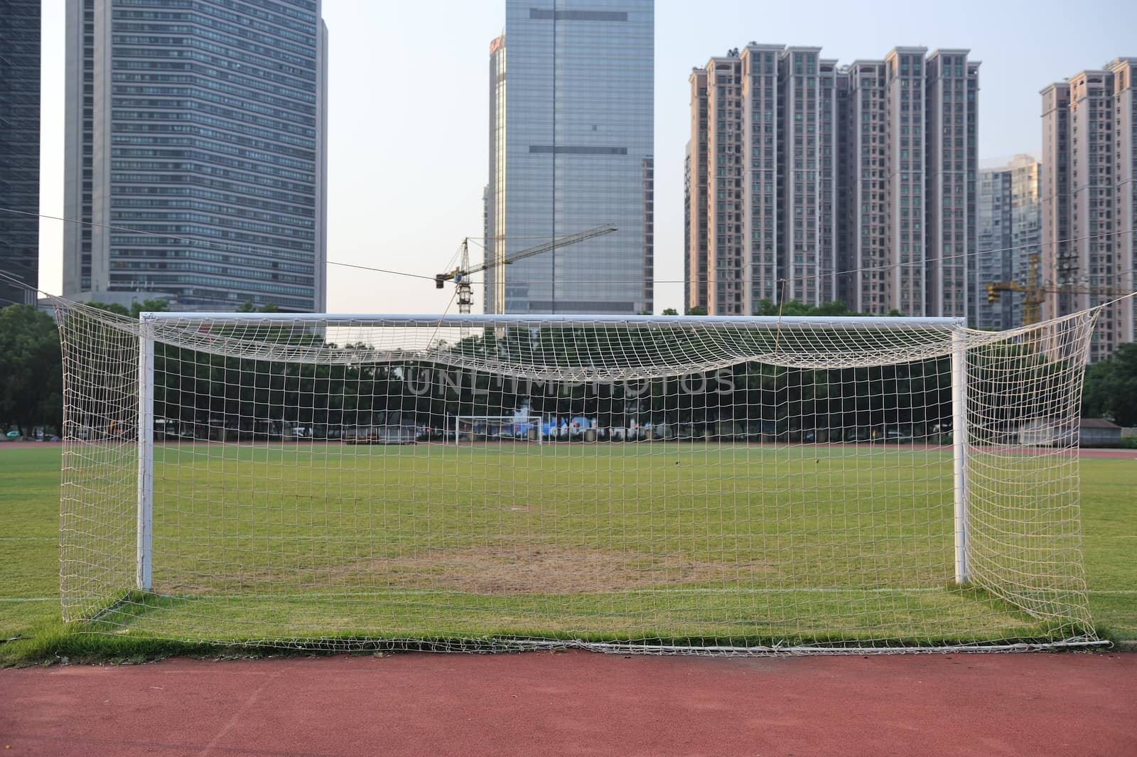 football goal with football field and buildings as background