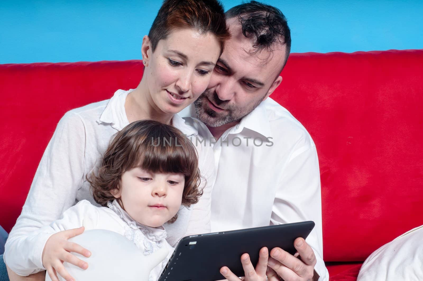 happy family using tablet at home by peus